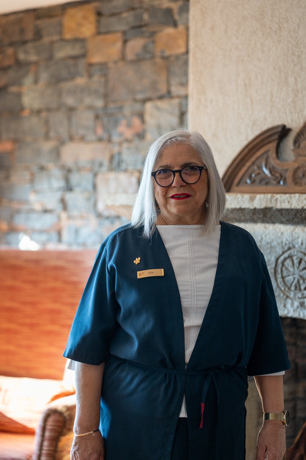 Working portrait of Eleni Neophytou at the Elounda Mare reception, where she has worked since the property opened in 1982.
