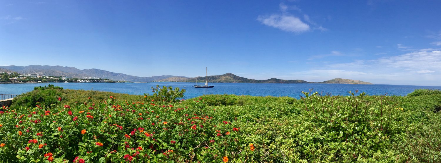 The Mirabello coast at dusk, looking across the gulf toward Spinalonga.